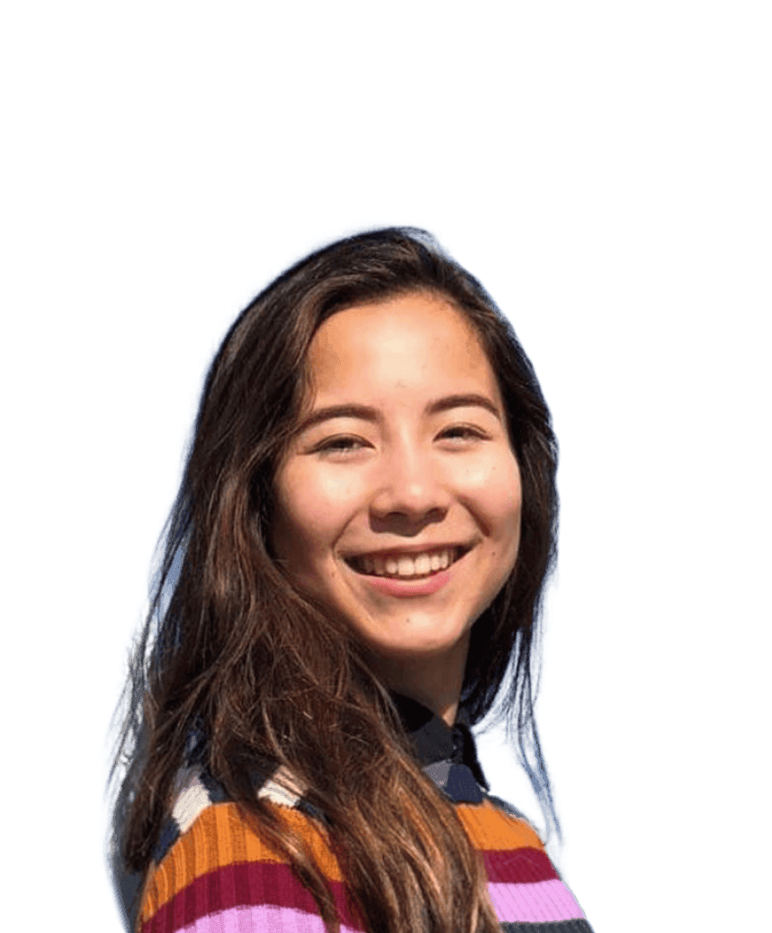 A woman wears a colourful horizontally striped jumper and smiles towards the camera.