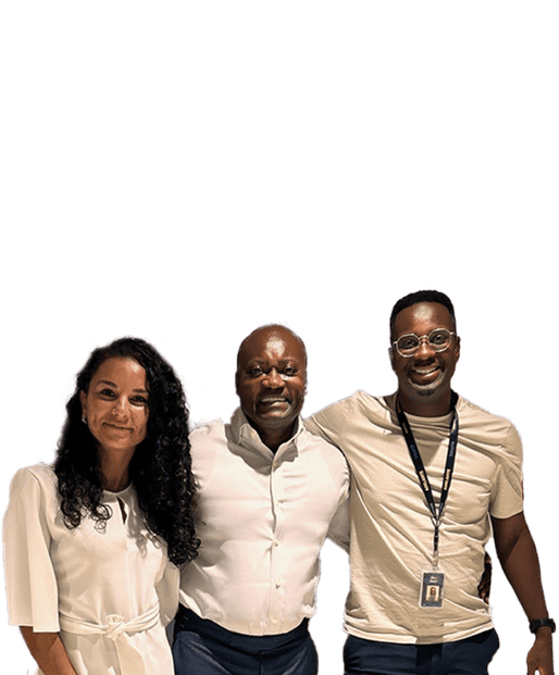 Group of 3 people, a woman next to a man, next to a man with their arms round each other smiling