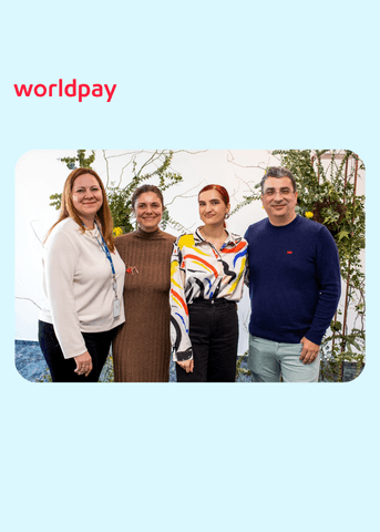 colleagues in an office with plants behind them