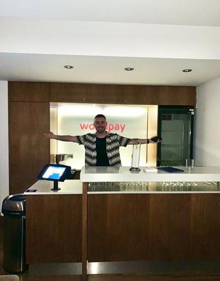 man standing in office with hands extended