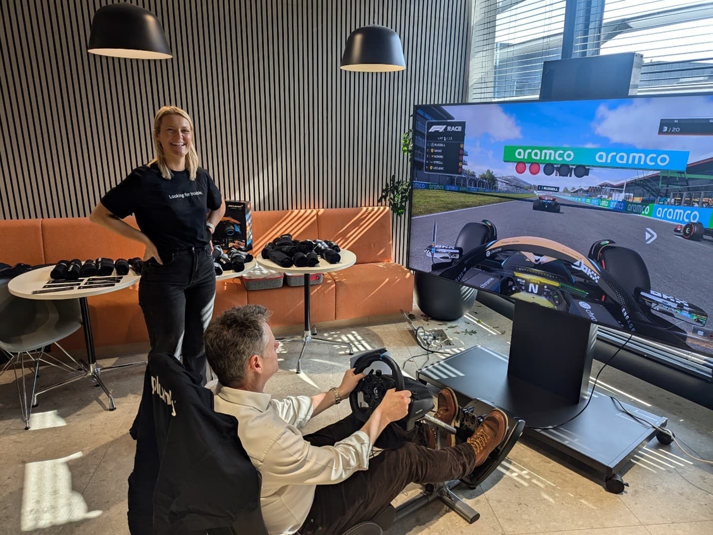technology male colleague driving stimulator race car in office setting